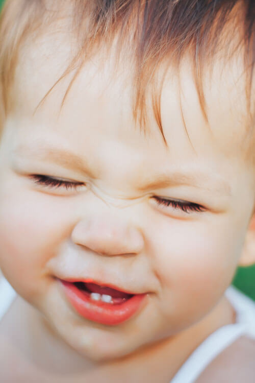 Baby Girl Laughing With Two Teeth